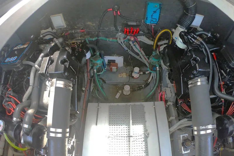 Slide: The Image of Engine compartment of a 1987 Sea Ray 390 Express, showcasing mechanical components and wiring. - 17