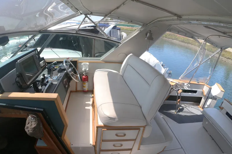 Slide: The Image of 1987 Sea Ray 390 Express yacht on dry dock under a clear blue sky. - 28