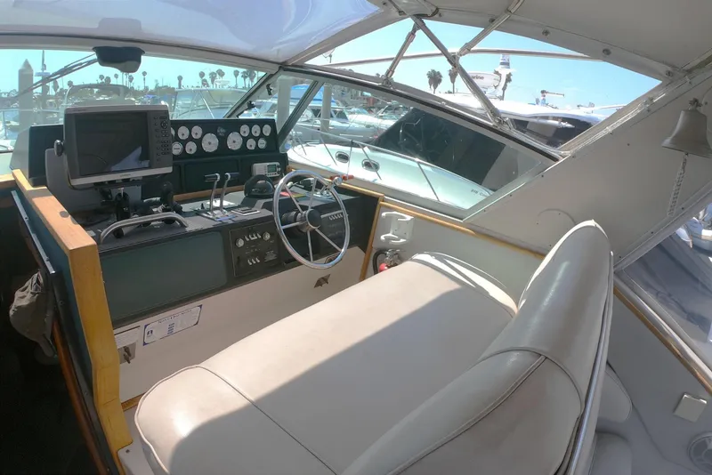 Slide: The Image of 1987 Sea Ray 390 Express cockpit with steering wheel, gauges, and navigation equipment. - 5