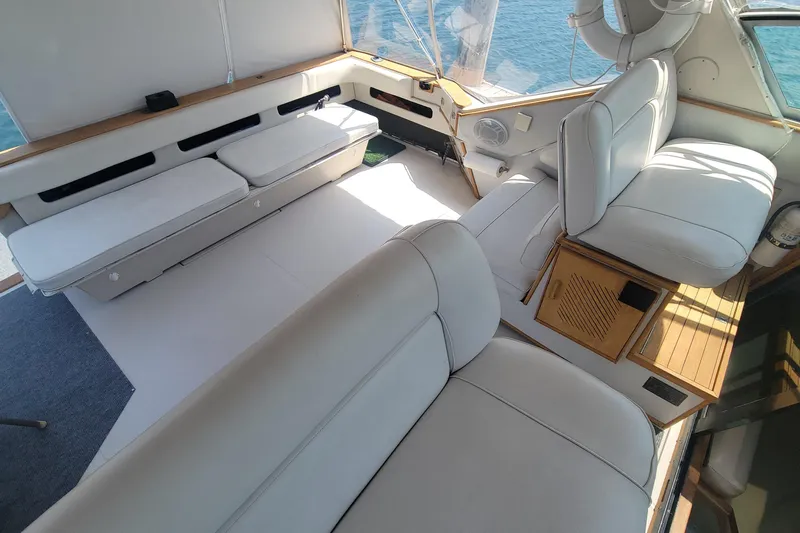 Slide: The Image of Interior of 1987 Sea Ray 390 Express with companion seat and wood accents. - 7