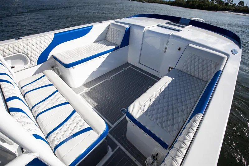 Slide: The Image of Luxurious 2018 Hann 53 boat interior with blue and white seating on the water. - 10