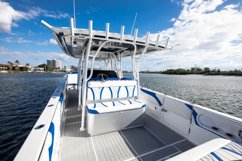 Slide: The Image of 2018 Hann 53 boat on water, featuring sleek design and spacious seating. - 12