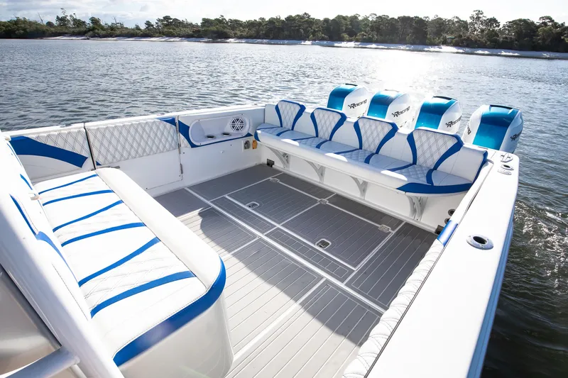 Slide: The Image of Spacious 2018 Hann 53 boat interior with blue and white seating on calm water. - 14
