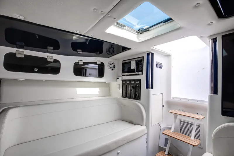 Slide: The Image of Interior of a 2018 Hann 53 boat with white seating and skylight. - 17