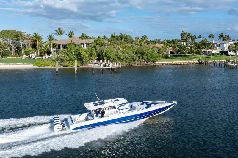 Slide: The Image of 2018 Hann 53 boat cruising on a scenic waterway near luxury waterfront homes. - 22