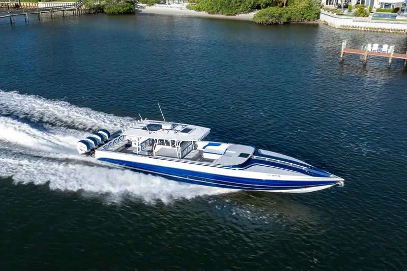 Slide: The Image of A 2018 Hann 53 boat cruising swiftly on a serene waterway. - 24