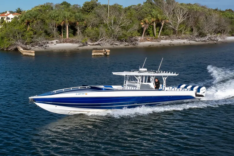 Slide: The Image of 2018 Hann 53 boat cruising near a lush, tropical shoreline. - 26