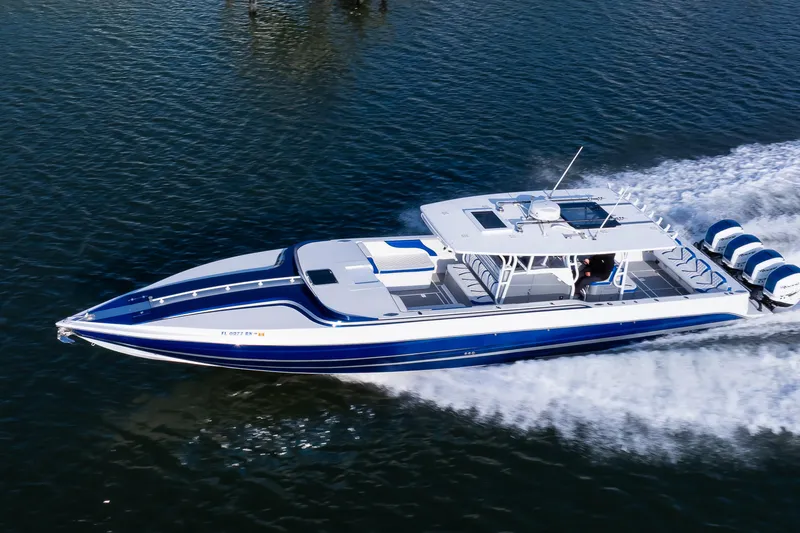 Slide: The Image of 2018 Hann 53 boat cruising on water with four outboard engines. - 30
