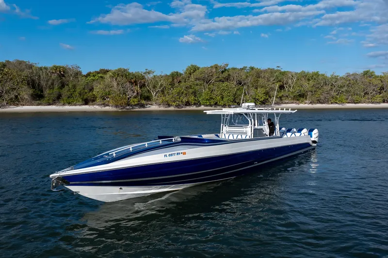 Slide: The Image of 2018 Hann 53 boat on water near a forested shoreline under a blue sky. - 4