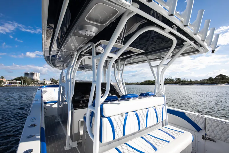 Slide: The Image of Luxury Hann 53 boat interior, 2018 model, featuring sleek seating and modern design on open water. - 8