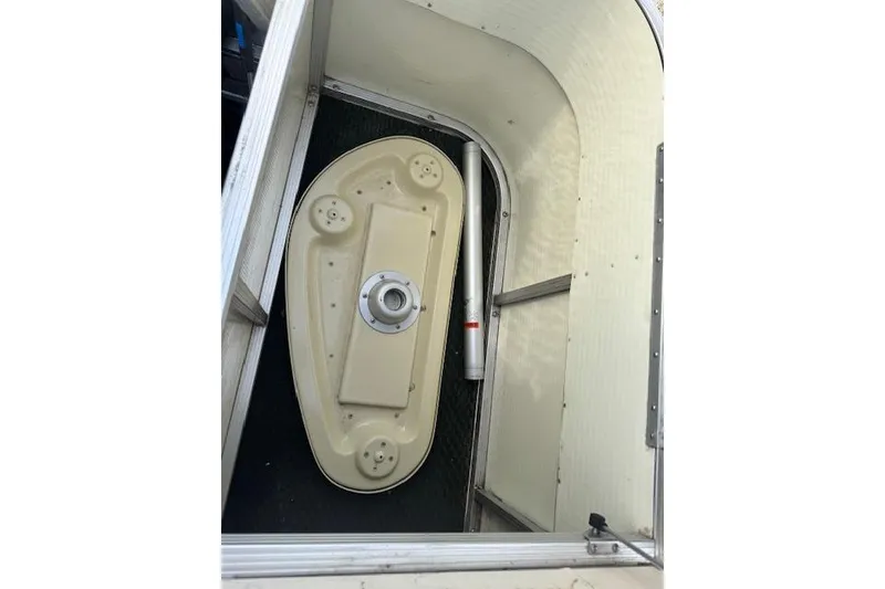 Slide: The Image of 2002 Bennington 2575RL I/O boat interior with beige table and metal frame. - 14