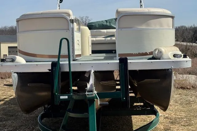 Slide: The Image of 2002 Bennington 2575RL I/O pontoon boat on trailer, beige and white exterior. - 15