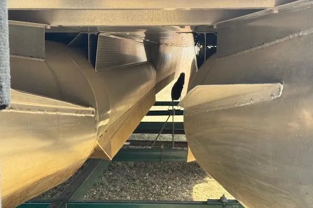 Slide: The Image of Underneath view of a 2002 Bennington 2575RL I/O pontoon boat on a trailer. - 16