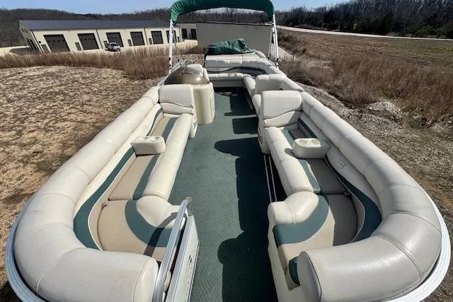 Slide: The Image of 2002 Bennington 2575RL I/O pontoon boat with spacious seating and green canopy. - 18