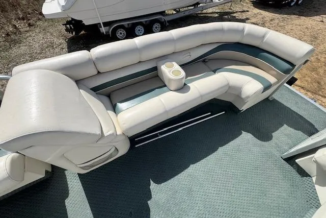 Slide: The Image of 2002 Bennington 2575RL I/O boat interior with cushioned seating and cup holders. - 19