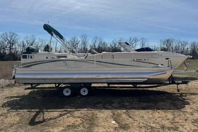 Slide: The Image of 2002 Bennington 2575RL I/O pontoon boat on trailer, parked outdoors. - 3
