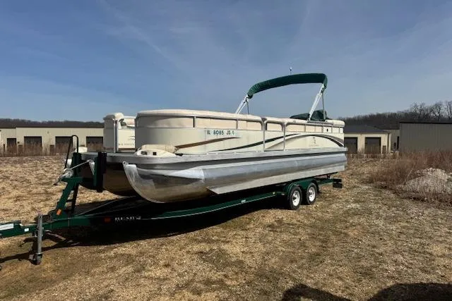 Slide: The Image of 2002 Bennington 2575RL I/O pontoon boat on trailer, parked outdoors. - 4
