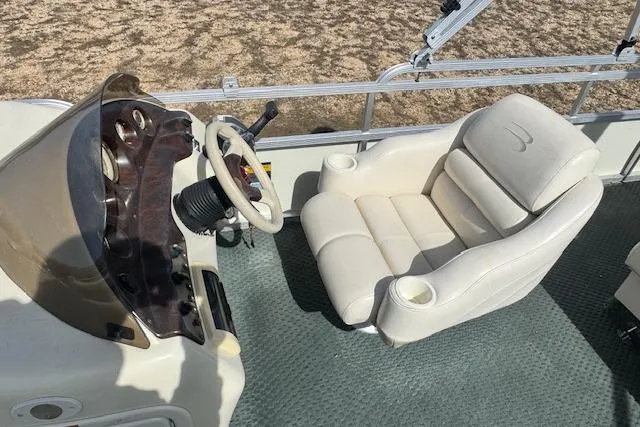 Slide: The Image of 2002 Bennington 2575RL I/O boat interior with steering wheel and plush captain's chair. - 9