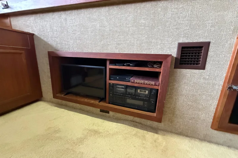 Slide: The Image of 1979 Viking 43 Double Cabin interior with built-in entertainment system and book. - 11