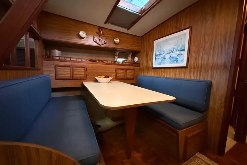Slide: The Image of 1979 Viking 43 Double Cabin interior with wood paneling and blue seating. - 14