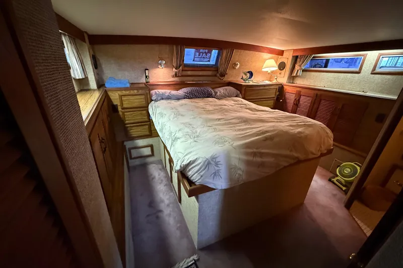 Slide: The Image of Cozy bedroom in a 1979 Viking 43 Double Cabin yacht with wood furnishings. - 16