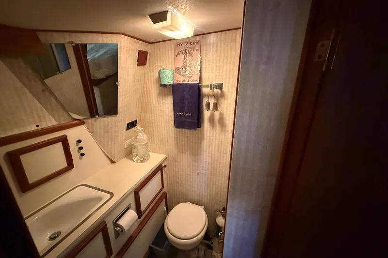Slide: The Image of 1979 Viking 43 Double Cabin bathroom with sink, mirror, and toilet. - 17