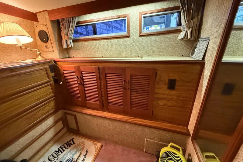Slide: The Image of Interior of a 1979 Viking 43 Double Cabin with wood paneling and cozy decor. - 18