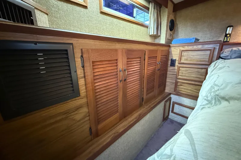 Slide: The Image of 1979 Viking 43 Double Cabin interior with wooden cabinets and cozy bedding. - 20