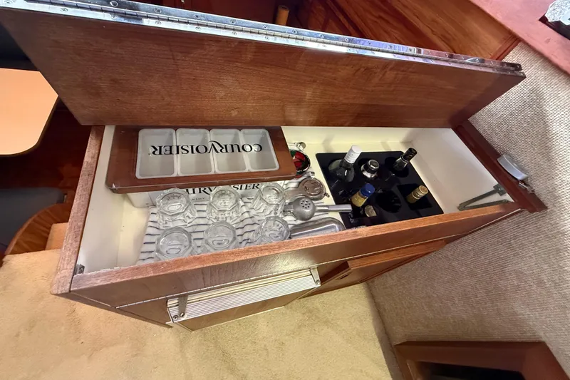 Slide: The Image of Bar cabinet with glassware and bottles in a 1979 Viking 43 Double Cabin yacht. - 21