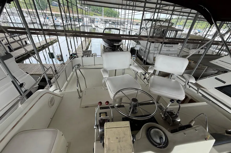 Slide: The Image of 1979 Viking 43 Double Cabin yacht interior with helm and seating at marina. - 4