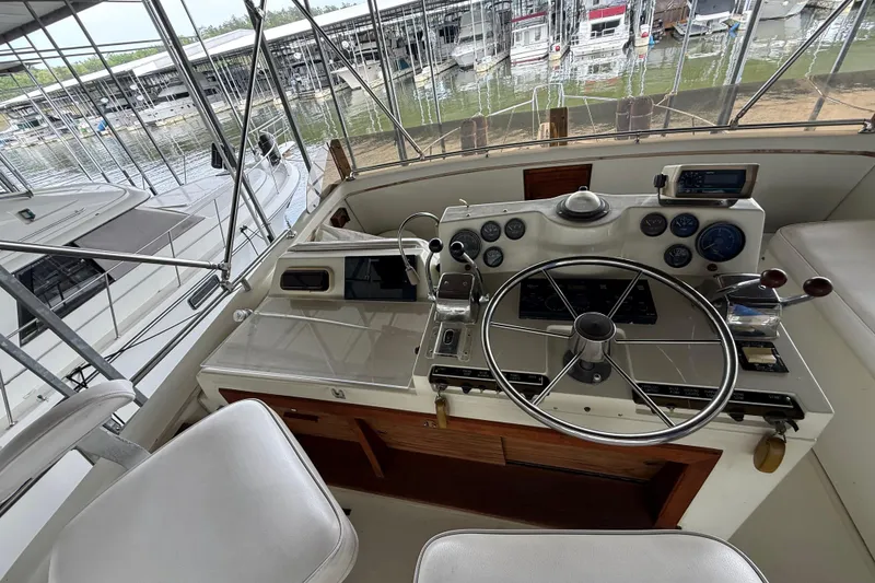 Slide: The Image of 1979 Viking 43 Double Cabin helm with steering wheel and control panel at marina. - 8