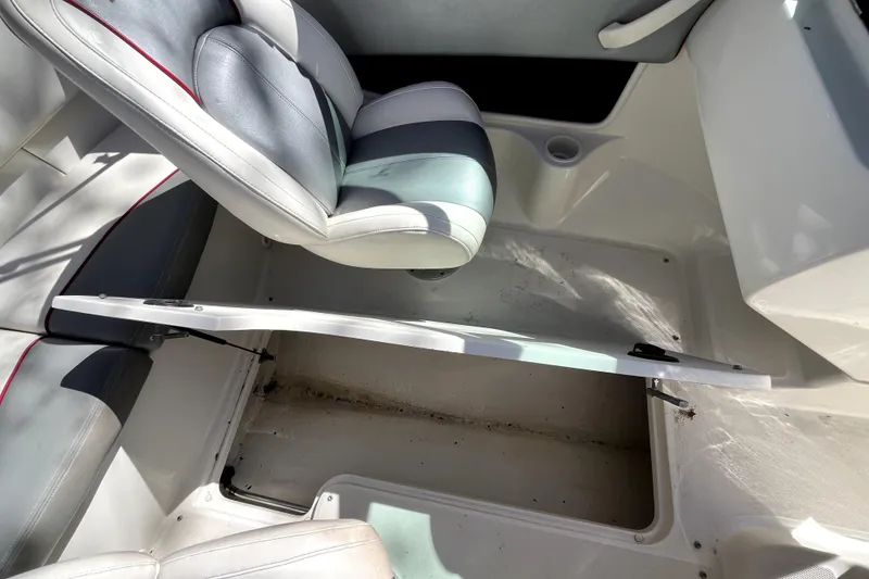 Slide: The Image of 2008 Sea Ray 185 Sport boat interior with open storage compartment. - 11
