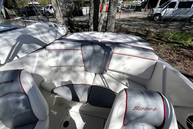 Slide: The Image of 2008 Sea Ray 185 Sport boat interior with white and gray seating, red accents. - 12
