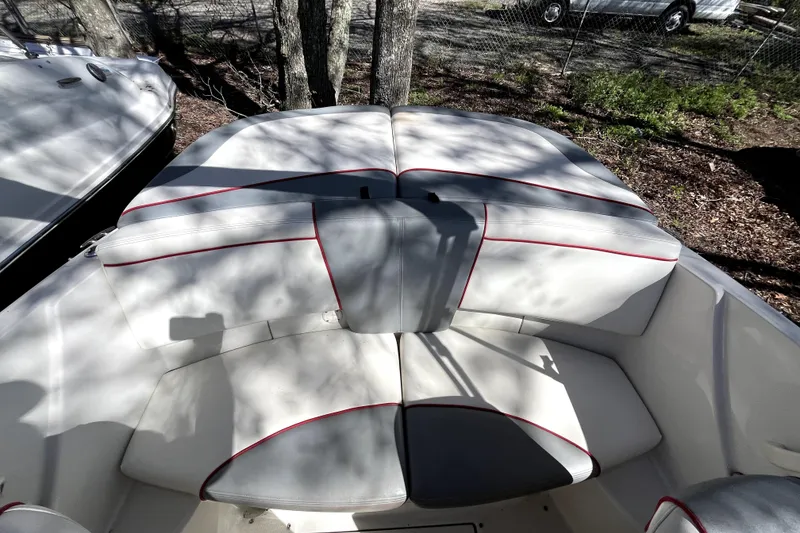 Slide: The Image of 2008 Sea Ray 185 Sport boat interior with white and red-trimmed seating. - 13