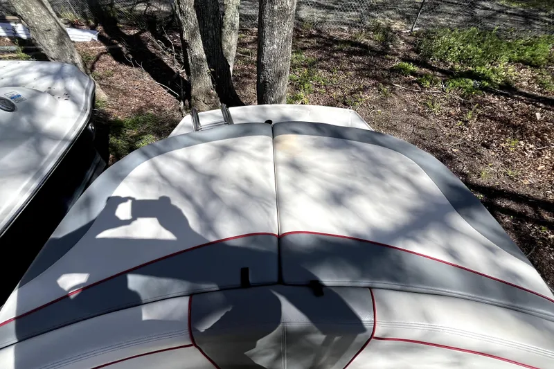 Slide: The Image of 2008 Sea Ray 185 Sport boat with white and red upholstery, parked outdoors. - 14