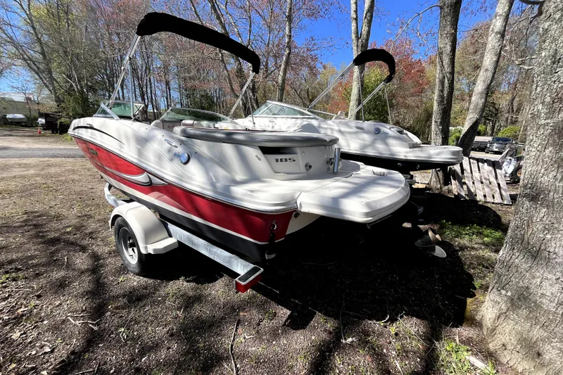 Slide: The Image of 2008 Sea Ray 185 Sport boat on trailer, parked outdoors among trees. - 3