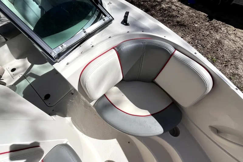 Slide: The Image of 2008 Sea Ray 185 Sport boat interior with gray and white seating. - 5