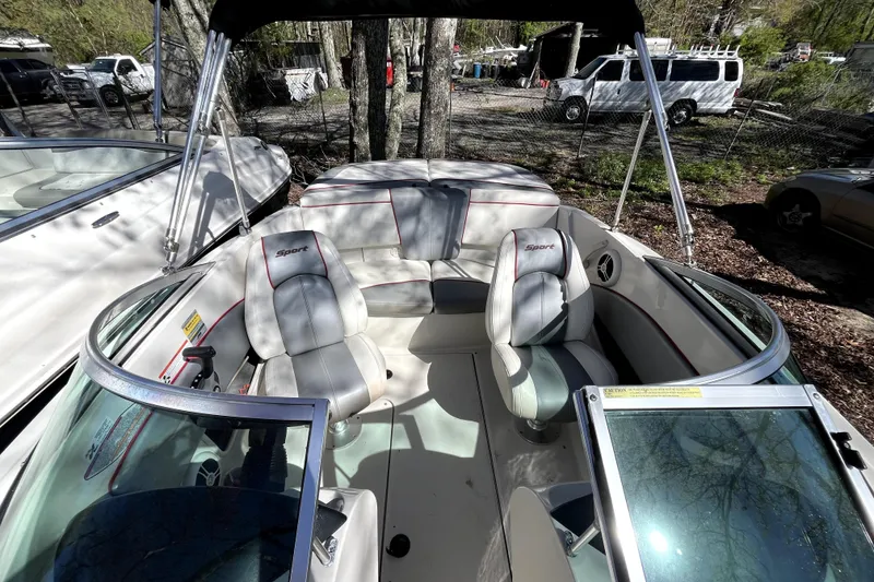 Slide: The Image of 2008 Sea Ray 185 Sport boat interior with white seating and open canopy. - 6