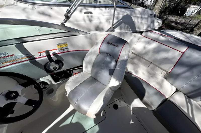 Slide: The Image of Interior of a 2008 Sea Ray 185 Sport boat with steering wheel and seating. - 9