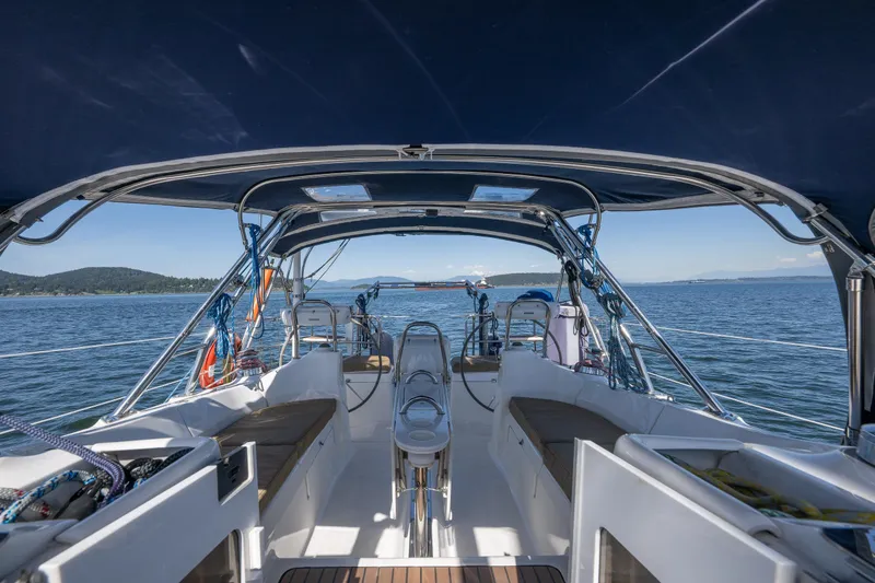 Slide: The Image of 2008 Hunter 45 Deck Salon sailboat cockpit with ocean view and blue canopy. - 17