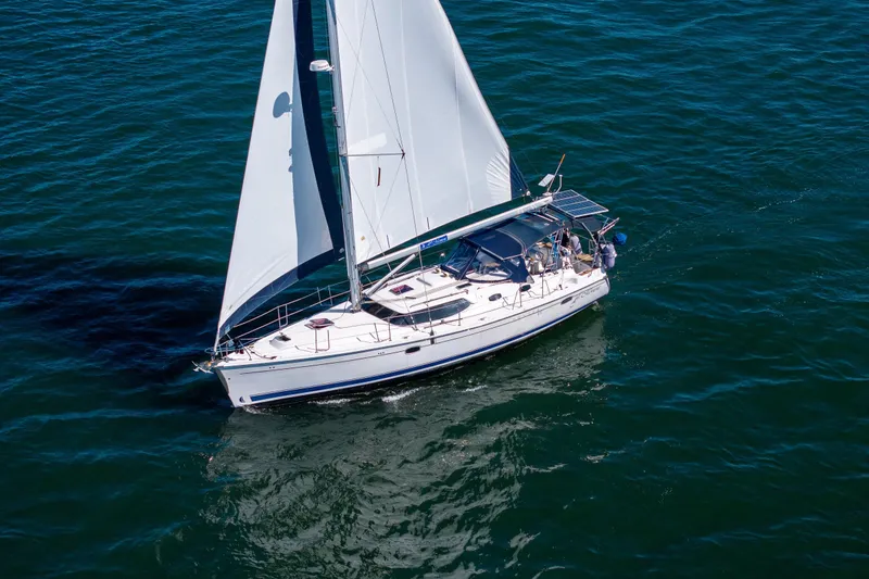 Slide: The Image of 2008 Hunter 45 Deck Salon sailboat cruising on open water. - 3