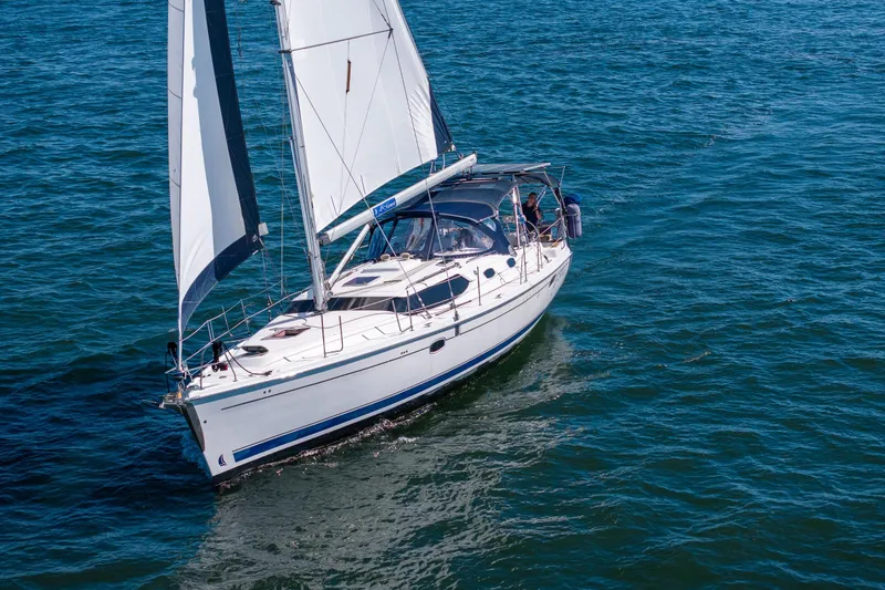 Slide: The Image of 2008 Hunter 45 Deck Salon sailboat cruising on open water. - 6