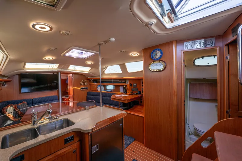 Slide: The Image of Luxurious interior of 2008 Hunter 45 Deck Salon yacht with modern amenities and wood finishes. - 9