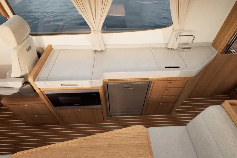 Slide: The Image of Modern kitchen interior of 2027 Targa TARGA 37 yacht with sleek design and wood accents. - 11