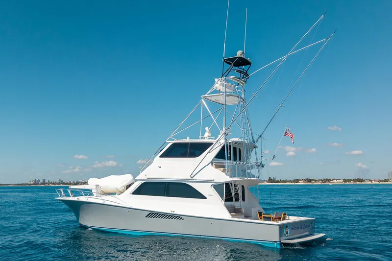The Image of 2005 Viking 61 Enclosed Bridge yacht cruising on clear blue waters. - 0