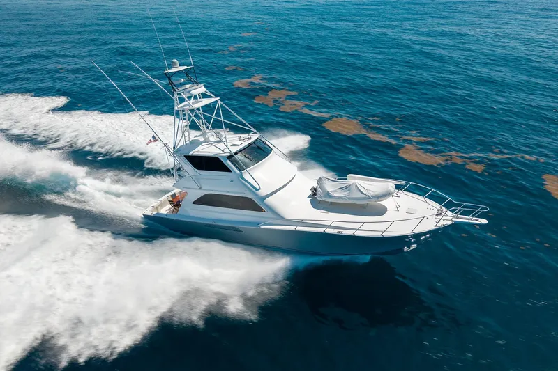 Slide: The Image of 2005 Viking 61 Enclosed Bridge yacht cruising on open ocean waters. - 12