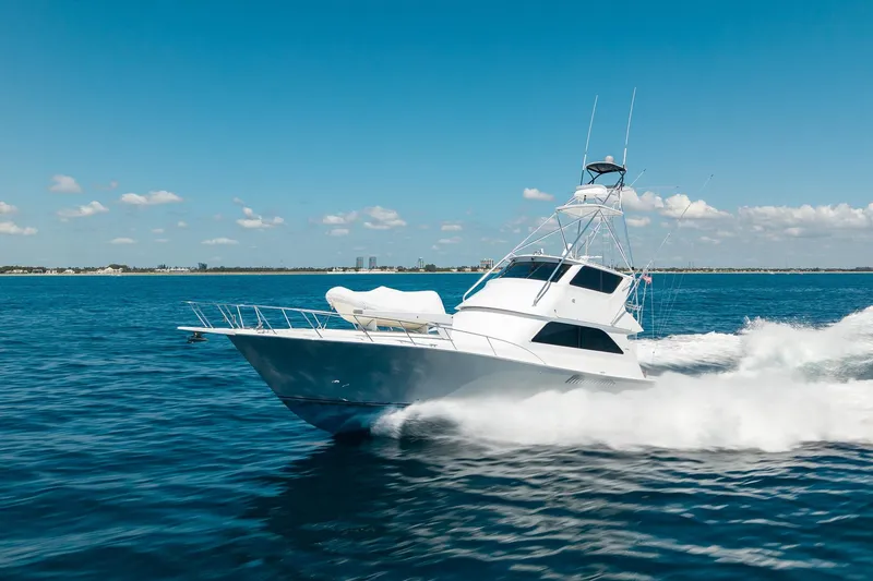 Slide: The Image of 2005 Viking 61 Enclosed Bridge yacht cruising on open water. - 14