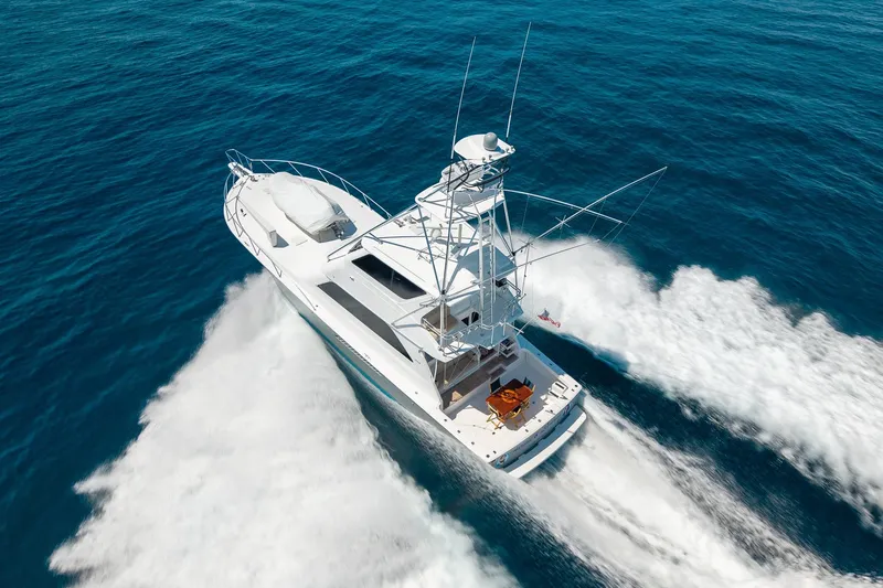 Slide: The Image of 2005 Viking 61 Enclosed Bridge yacht cruising on open blue waters. - 15