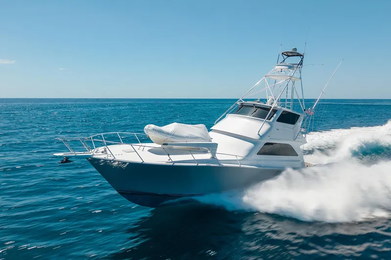 Slide: The Image of 2005 Viking 61 Enclosed Bridge yacht cruising on open sea. - 17