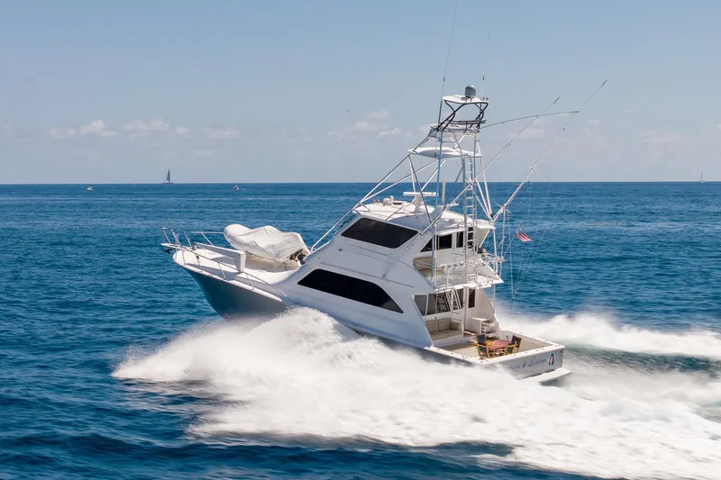 Slide: The Image of 2005 Viking 61 Enclosed Bridge yacht cruising on open ocean waters. - 18